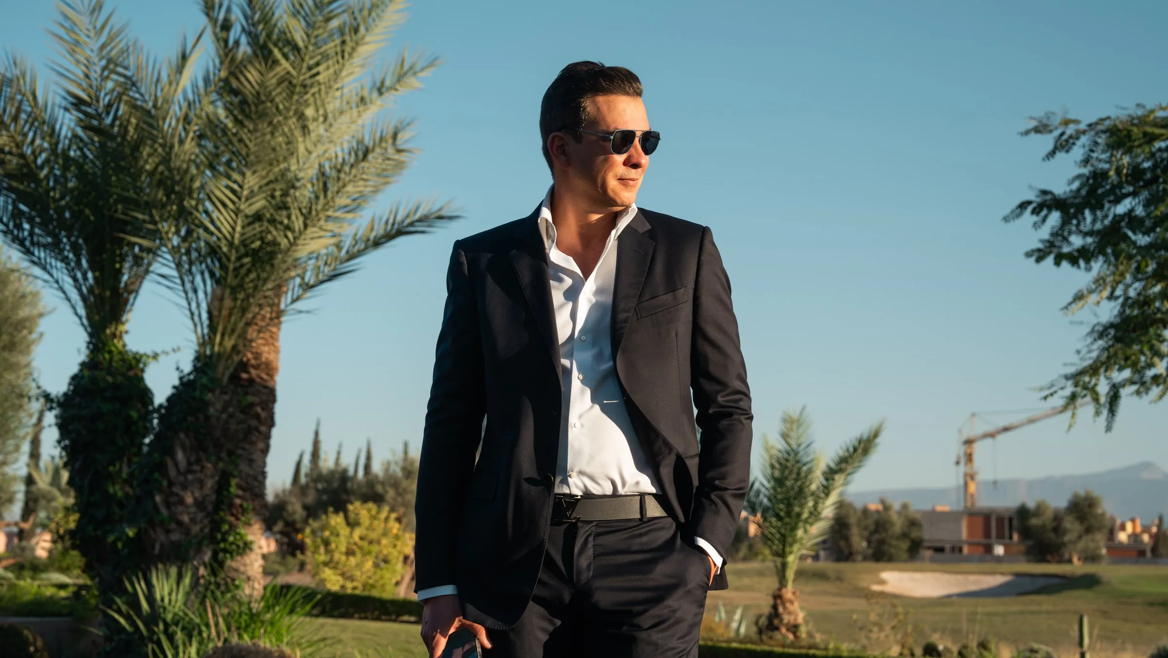 Lifestyle shoot: a surgeon in a dark suit on a golf course in Marrakech