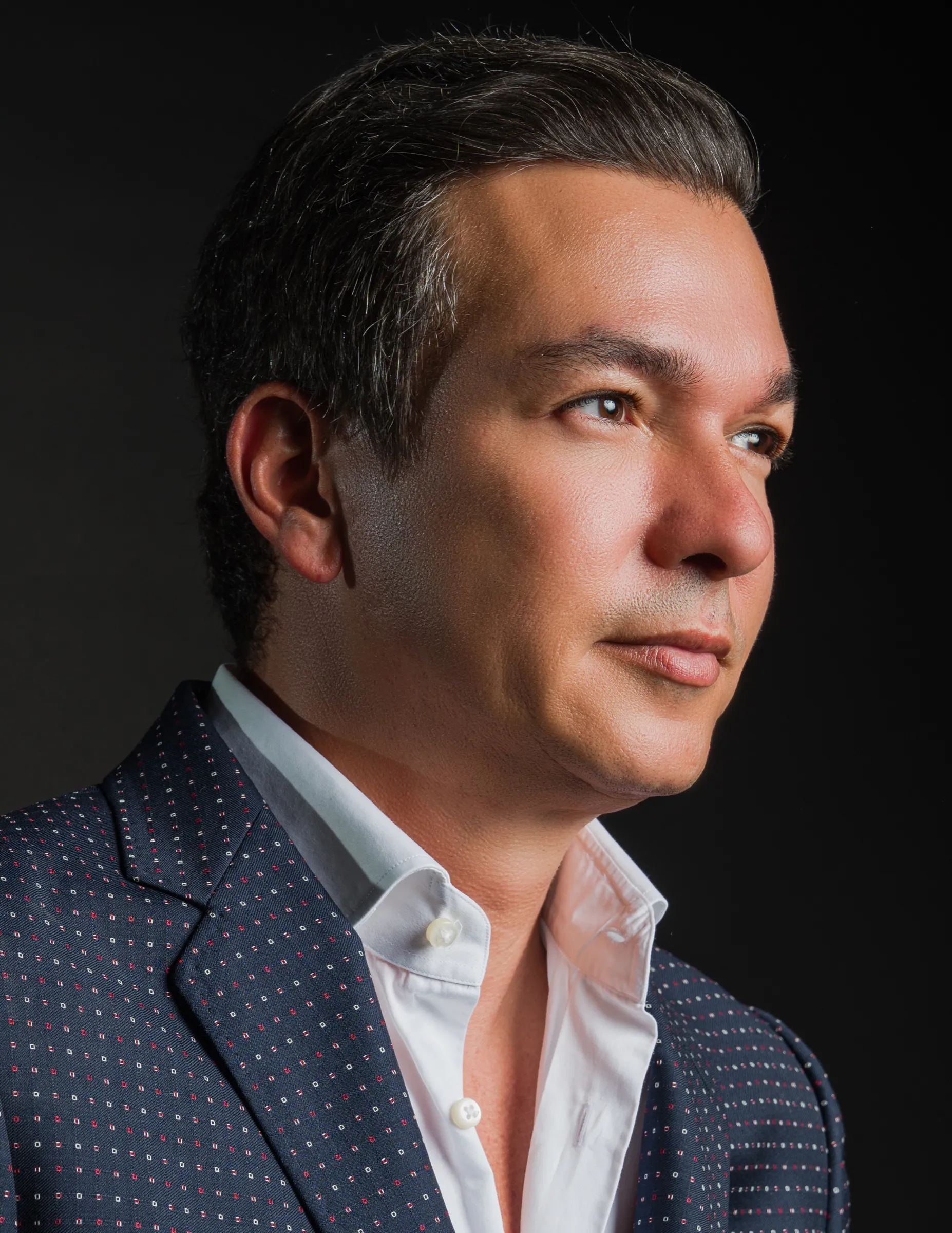 Studio portrait of a plastic surgeon, lit from the side