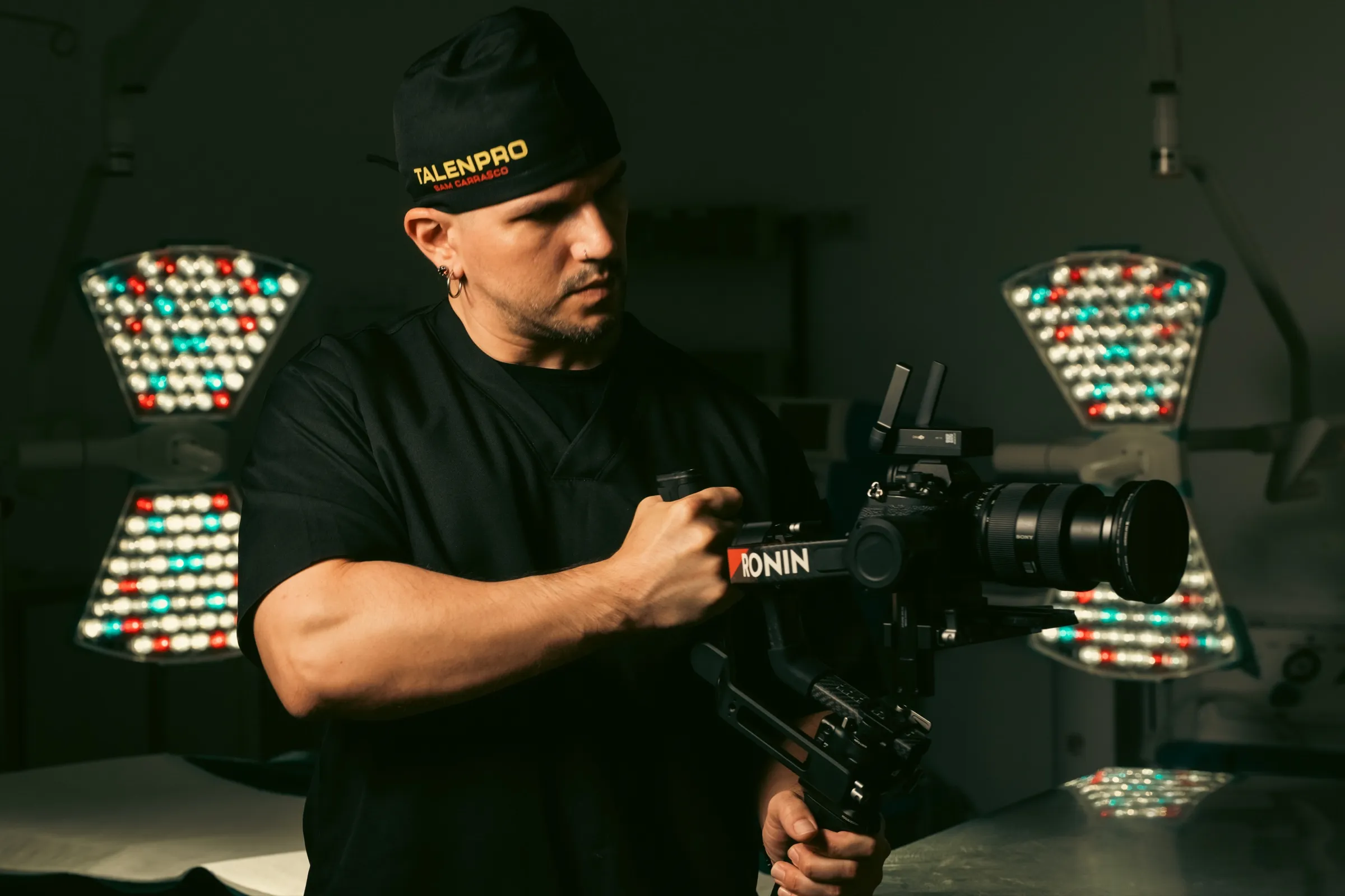 Sam Carrasco with a cinema camera between operating lamps