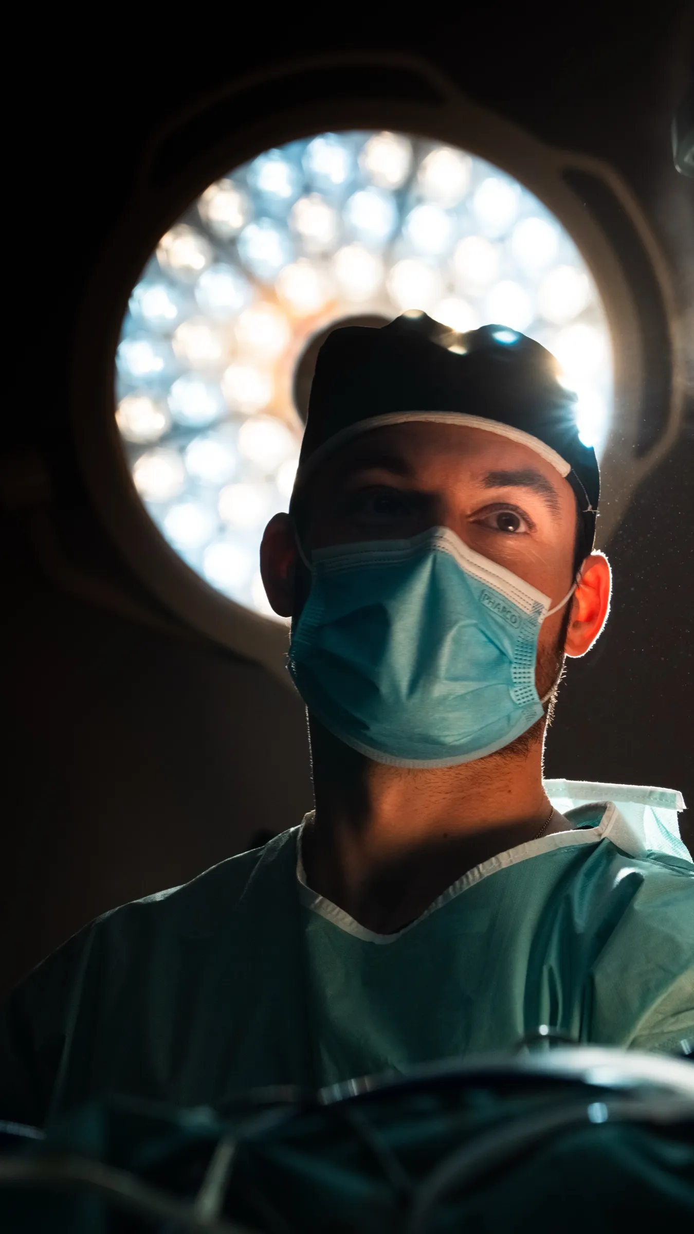 Surgeon framed by the operating lamp